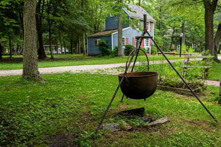 Cold Spring Village, Cape May, NJ, USA - June 18, 2019: historic fireplace with tripod and metal boilerのeditorial素材
