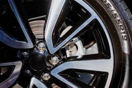 Car wheel with painted and chrome wheel, close-up  - image