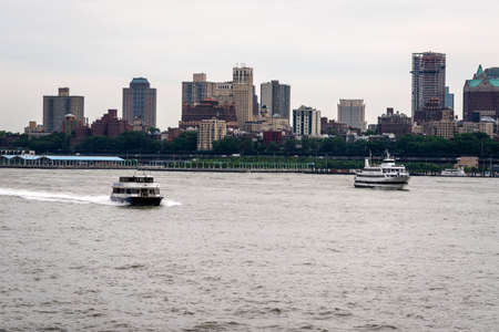 New York, USA - June 7, 2019:  Tourist boats on East River in front of Manhattan, A East River ferry boat travels the Hudson River - Imageのeditorial素材