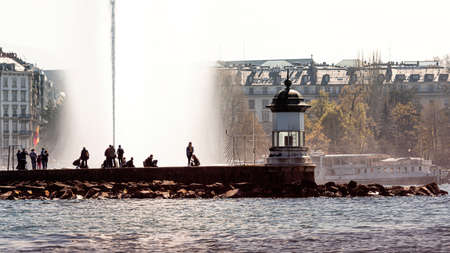 Geneva, Switzerland - April 15, 2019: Beautiful view of the water jet fountain in the lake of Geneva...