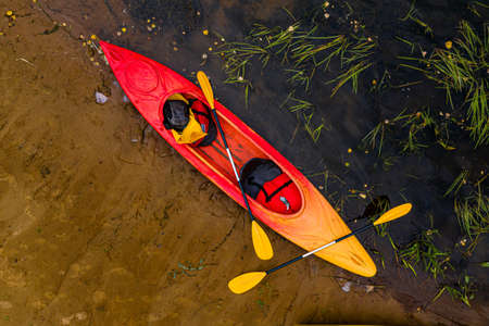 multicolored empty kayaks on the river bank, top down viewの写真素材