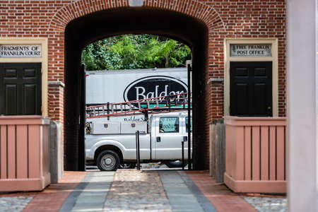 Philadelphia, Pennsylvania, USA - June 17, 2019: red brick house entrance arch to the old courtyards...