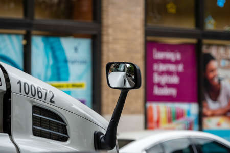 Philadelphia, Pennsylvania, USA - June 17, 2019: close-up of a rear-view mirror of a truck on a...