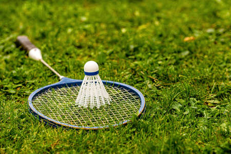 Badminton rackets and shuttlecock on green grassの写真素材