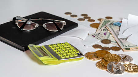 money, calculator, pen, paper, notebook and glasses on white background, financial analytics...
