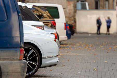 the yard of the houses of the city residential area with parked cars