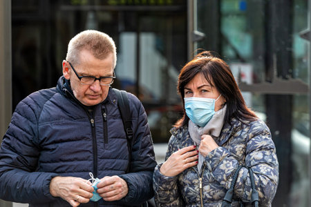 Riga, Latvia - November 6, 2020: people in medical face masks on city streets during coronavirus pandemic restrictions, a concept to fight the spread of covid-19 virusのeditorial素材