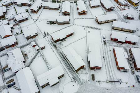 top view of the winter village with snow covered houses and roads, view from aboveの写真素材