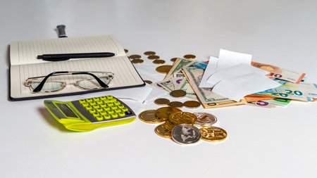 money, calculator, pen, paper, notebook and glasses on white background, financial analytics concept, calculating budget, flat lay, close-upの写真素材