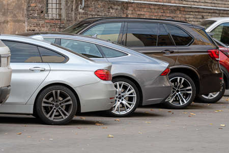 closeup of back side of parked cars in outdoor parking area