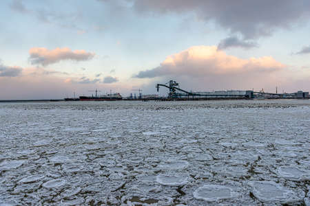 beautiful winter landscape with ship in cargo port fuel terminal at sunset time., Ventspils terminal, Latviaの写真素材