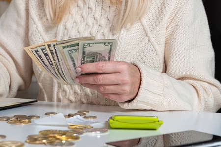 close up of woman hands counting us dollar money, female finance staff counting money, finance, saving and banking conceptの写真素材