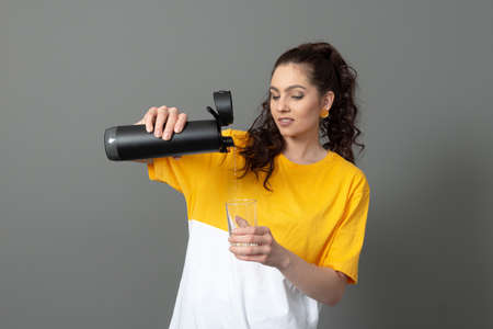 teenager holding eco reusable smart thermo water bottle with drink reminder, health care conceptの写真素材