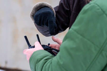 area planners survey the surroundings with a drone, close-up of a hand with a drone remote...