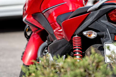 red modern motorcycle close-up, selective focus, focus on shock absorber