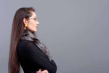 portrait of sensual female in glasses  with long hair against gray backgroundの写真素材