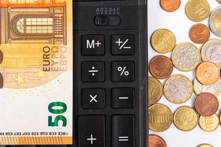 close-up of euro currency coins, banknotes and calculator, finance planning conceptの写真素材