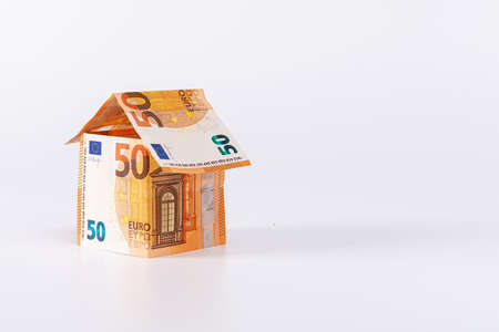 abstract house made of 50 euro banknotes isolated on a light background, home loan concept