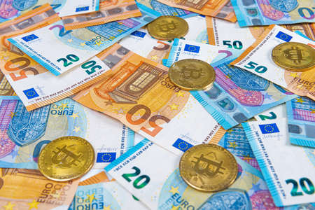 Bitcoin coins on euro banknotes background. Stock Market of cryptocurrencies and decentralized finances conceptの写真素材