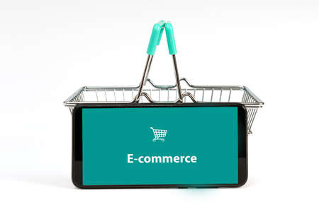 smartphone and small shopping basket isolated on white background, online shopping conceptの写真素材