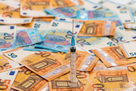 Close-up syringe and euros banknotes bills. Cost of health, medicine, drug conceptの写真素材