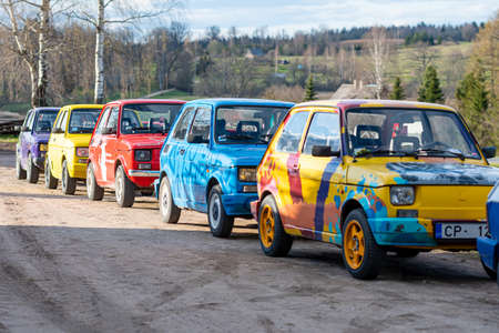 Madona, Latvia - May 01, 2021:  row of colorful stylish vintage Fiat 126 PanCars rental cars,...