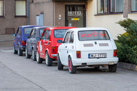 Madona, Latvia - May 01, 2021: several colorful oldtimer rental cars Fiat 126 parked in the yard