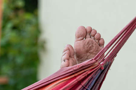 man is chilling and relaxing in the hammock, selective focus, focus on the feet