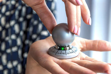 hand spinning the wheel of opportunity, pointer on YOU ARE FIRED, concept of failure.