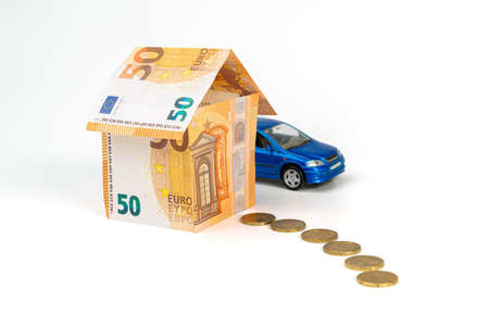House from euro banknotes, vehicle and path from coins isolated on white. loan, insurance conceptの写真素材
