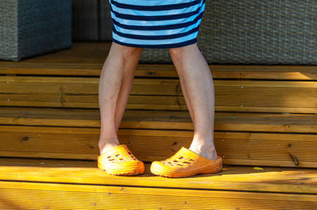 close up of woman feet in rubber shoes