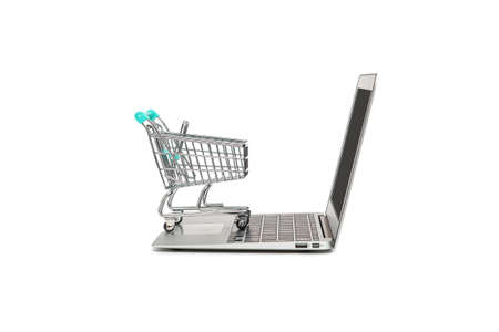 online shopping concept with laptop computer and shopping cart isolated on white background with...