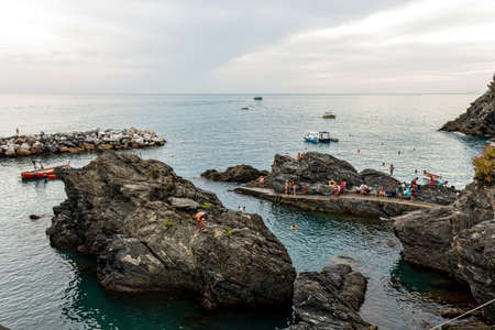 view of the harbor between the cliffs near the village of Manarola in the Cinque Terre National Park