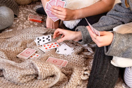 hands of people playing cards at home, selective focus, focus on cardsの写真素材