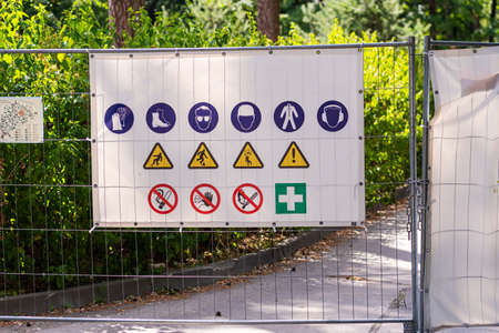 Information panel with forbidden and permissible signs at the construction site metal fenceの写真素材