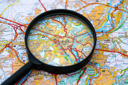 map of Liege in Belgium through magnifying glass, concept of planning the travel itineraryの写真素材