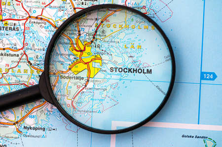 map of Stockholm in Sweden through magnifying glass, concept of planning the travel itinerary