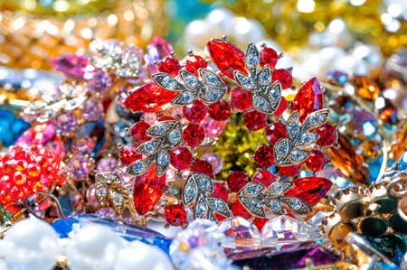 abstract background from various colorful bright jewelry and costume jewelry, soft, selective focusの写真素材