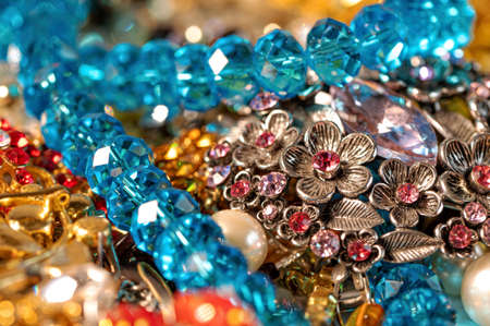 abstract background from various colorful bright jewelry and costume jewelry, soft, selective focus
