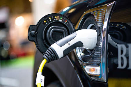 Riga, Latvia, Sep 24, 2021: Mini Countryman Plug-In Hybrid connected to the charger, charging an hybrid car at the stationのeditorial素材