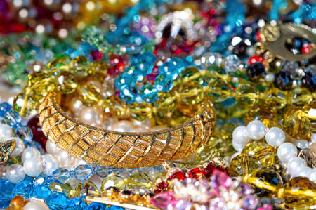 abstract background from various colorful bright jewelry and costume jewelry, soft, selective focusの写真素材
