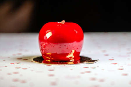 homemade apple-shaped cream cake with icing on a white background with hearts, closeupの写真素材