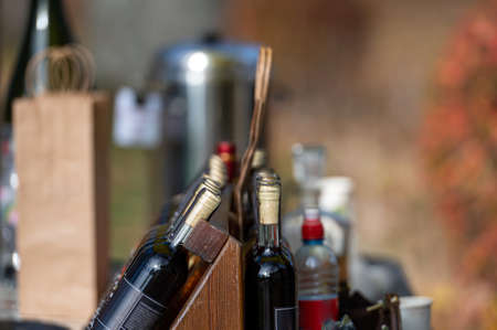 alcohol bottles on a stand on a bar or store counter, closeup, selective focusの写真素材