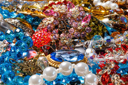 abstract background from various colorful bright jewelry and costume jewelry, soft, selective focusの写真素材