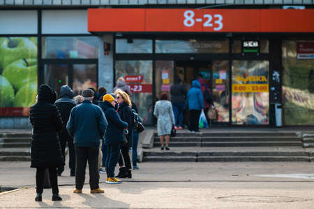 Riga, Latvia, November 2, 2021: shoppers stand in line and wait to get to the store given the constraints of the Covid-19 pandemicのeditorial素材