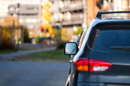 car parked on the street in residential district, back view, closeup of rear headlight