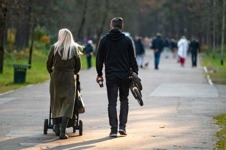 Riga, Latvia, October 30, 2021:  a family with children walks in the park on a sunny autumn afternoonのeditorial素材