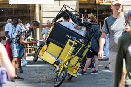 Florence, Italy - August 11, 2021: driver repairs a rickshaw in a crowded square near the Basilica of Santa Maria del Fioreのeditorial素材