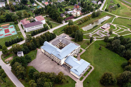 view from above to the small Latvian town Auce, two schools, a bicycle track and a residential areaの写真素材