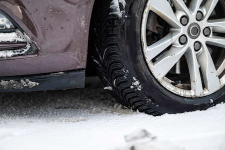 close-up of car wheels rubber tires in deep winter snow, transportation and safety conceptの写真素材